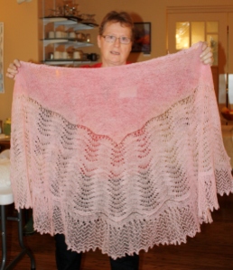 Anne displaying one of her lace shawls at the 2013 Retreat.