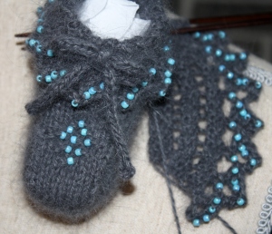 Booties in progress - they are finished now!  But this picture shows the lace well.  The booties need a name, any suggestions?