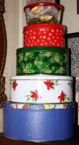 Stacks of Christmas tins filled with goodies.