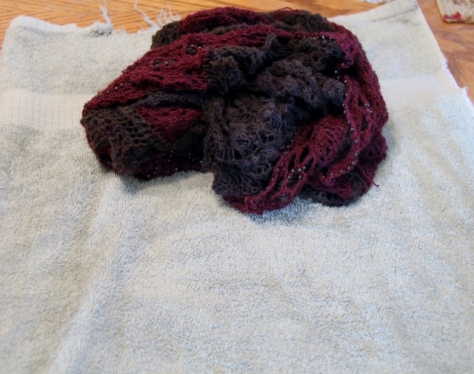 After gently squeezing - roll the shawl into a towel.